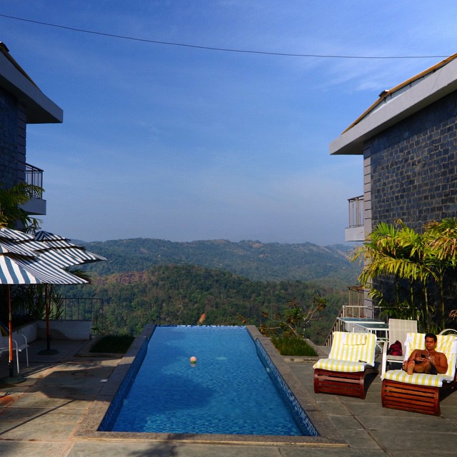 This is Luis relaxing on the super comfortable lounge chairs at the pool at the Ragamaya Resort.  Only downside is that there are only 2 of these, but thankfully we were the only ones trying to use them when we visited. You can not beat the view from the edge of this infinity pool in Munnar. WOW.