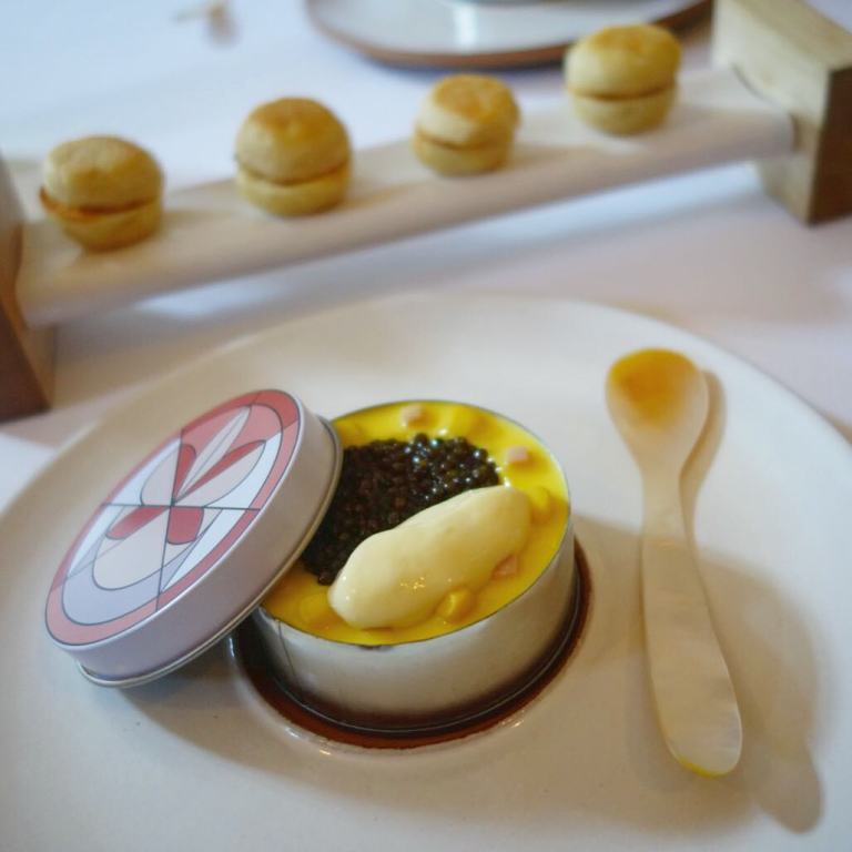 Eleven Madison Park - Birthday dinner - Caviar Eggs Benedict - bacon gelée, poached quail egg, corn & ham, topped with corn liquor reduction/jelly and caviar served with homemade english muffins