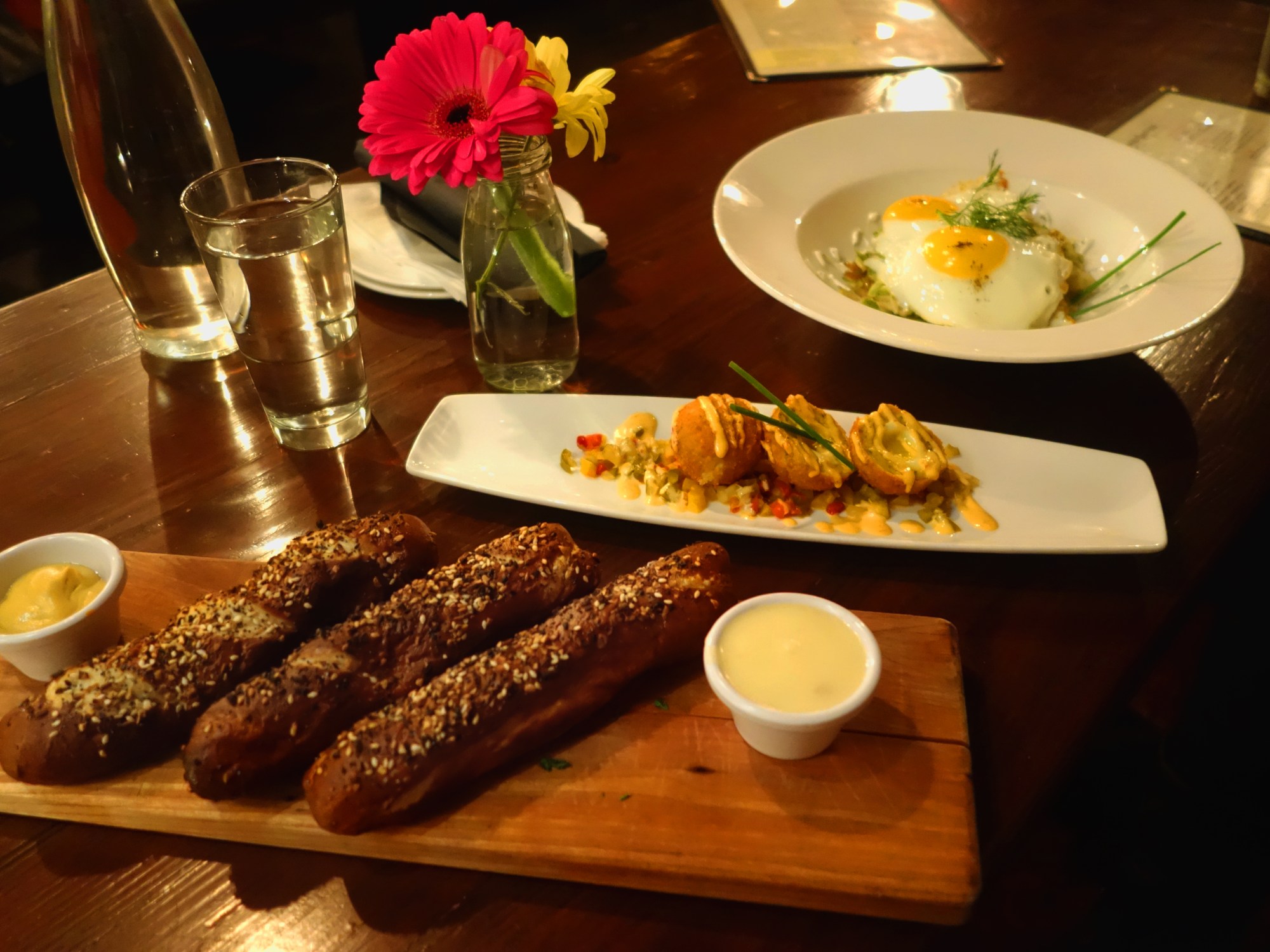 Tanner Smiths – Midtown NYC Front to back - Everything pretzel sticks with IPA cheese dip and mustard dip Brussels sprout hash with fried eggs and dill crème fraiche. Yardbird Scotch eggs with cherry pepper relish and aioli