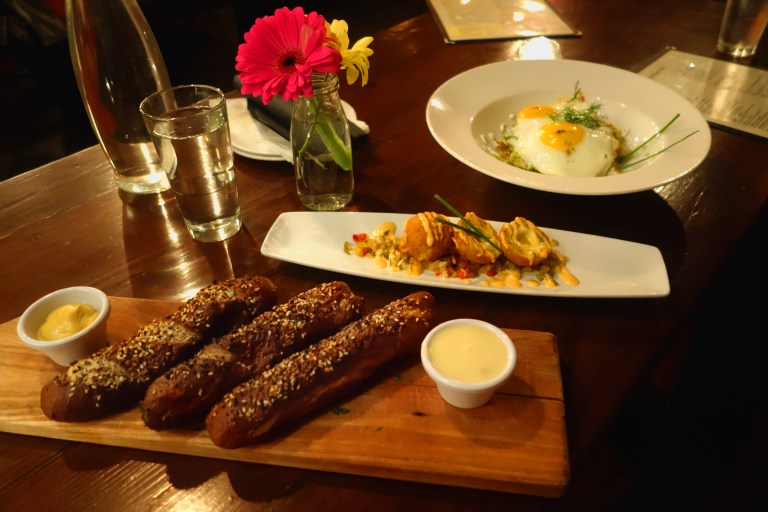 Tanner Smiths – Midtown NYC Front to back - Everything pretzel sticks with IPA cheese dip and mustard dip Brussels sprout hash with fried eggs and dill crème fraiche. Yardbird Scotch eggs with cherry pepper relish and aioli