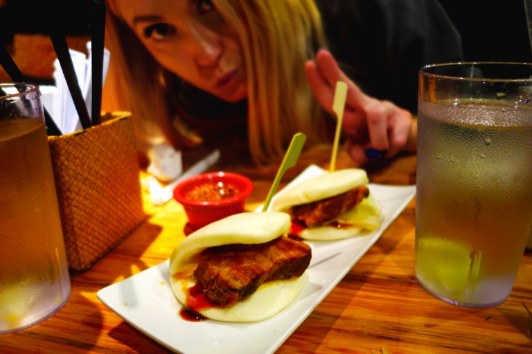 Totto Ramen - Midtown 52nd Street NYC - Alycia with their delicious char siu pork buns and lots of spicy oil on the side