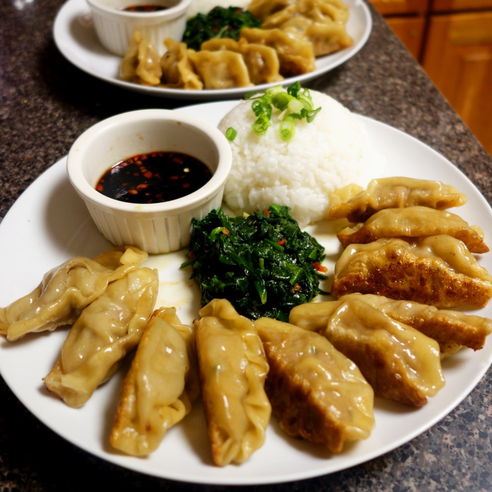Chinese New Year: Dim Sum Pork Dumplings - fried, steamed then plated with spicy sesame spinach and rice