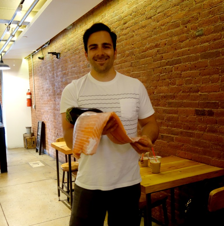Jon Eisen holding a beautiful piece of Ocean caught Norwegian salmon. Fresh, never frozen.