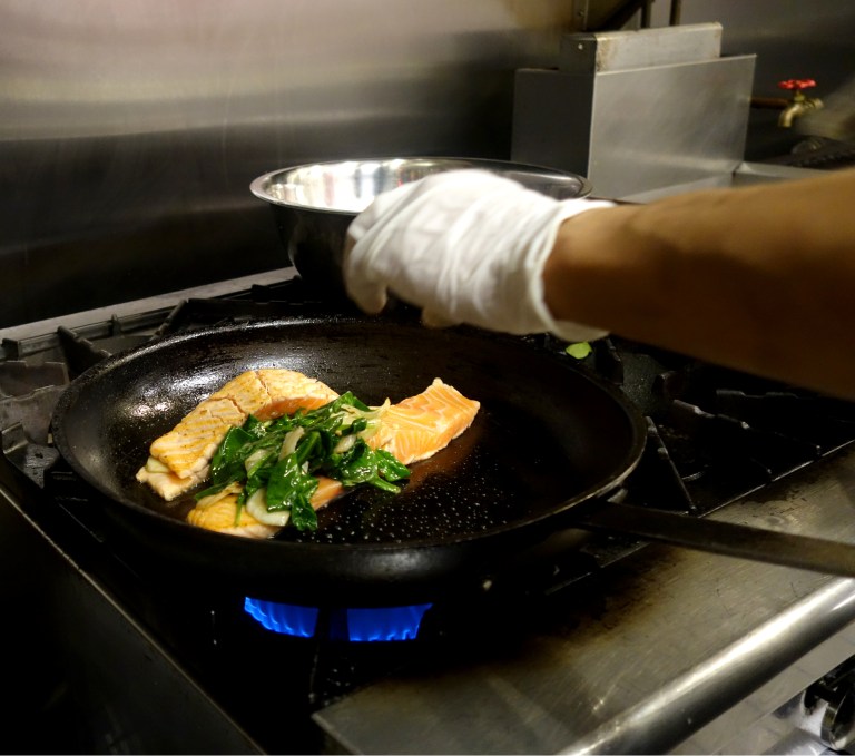 The split salmon being filled. Next the pan is transferred to a 350 degree oven and baked for 13 minutes.