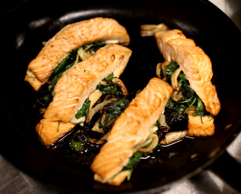 Stuffed salmon is baked and ready to be plated.