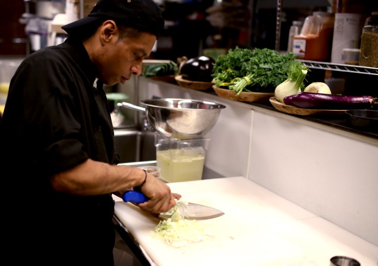 While the salmon roasts chef Juan slices the leeks very thinly.