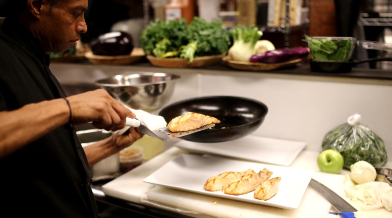 Chef Juan plating the grilled salmon.
